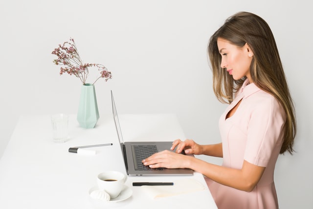 A woman attending a virtual showing online