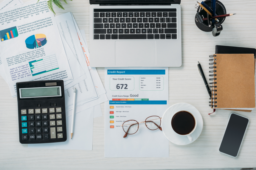 Desk with credit report and other office supplies.