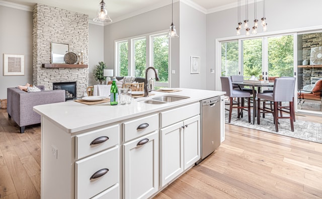 A large and bright open-plan living room with kitchen and dining room.