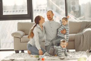 Parents with two kids sitting on the floor