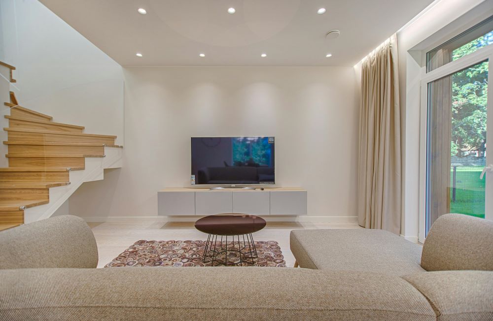 A beautiful living room with a brown couch and a flat-screen TV