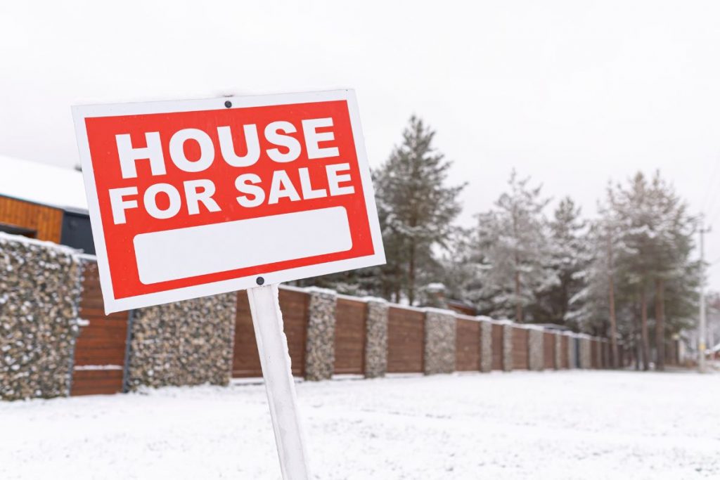 For sale sign in front of a Berwyn single-family home in winter