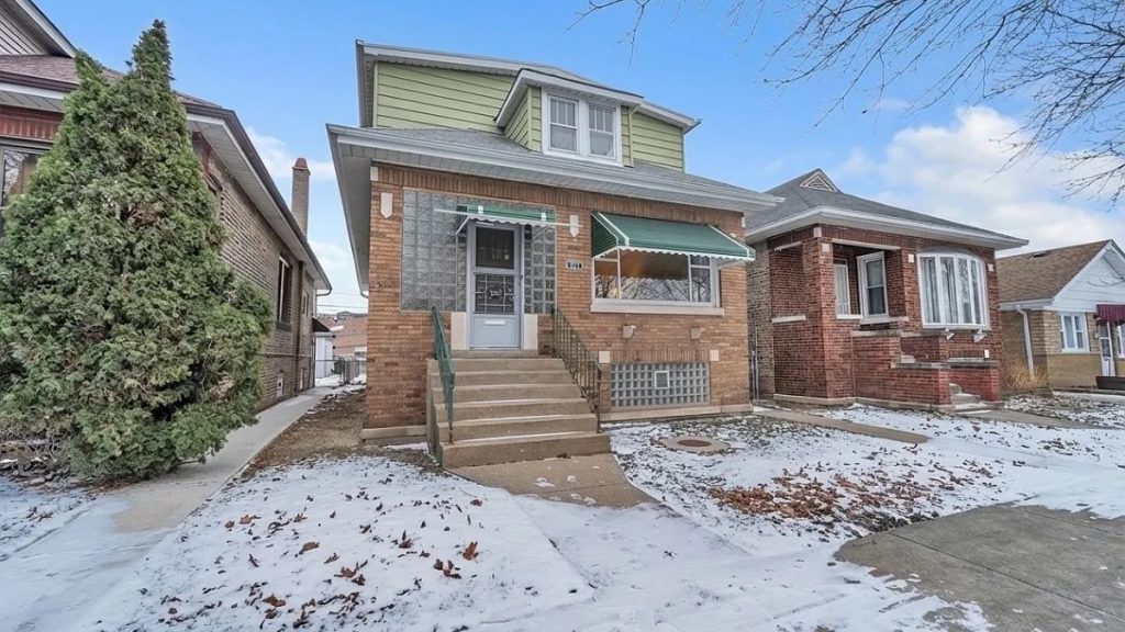 Berwyn IL homeowner standing on front porch considering whether to sell their home