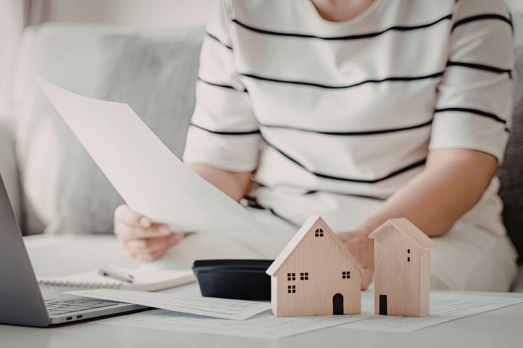 seller comparing real estate offers contract paperwork