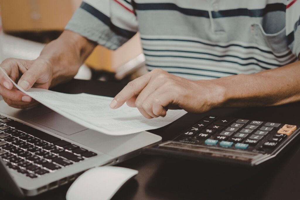 Homeowner comparing real estate offers before making a selling decision