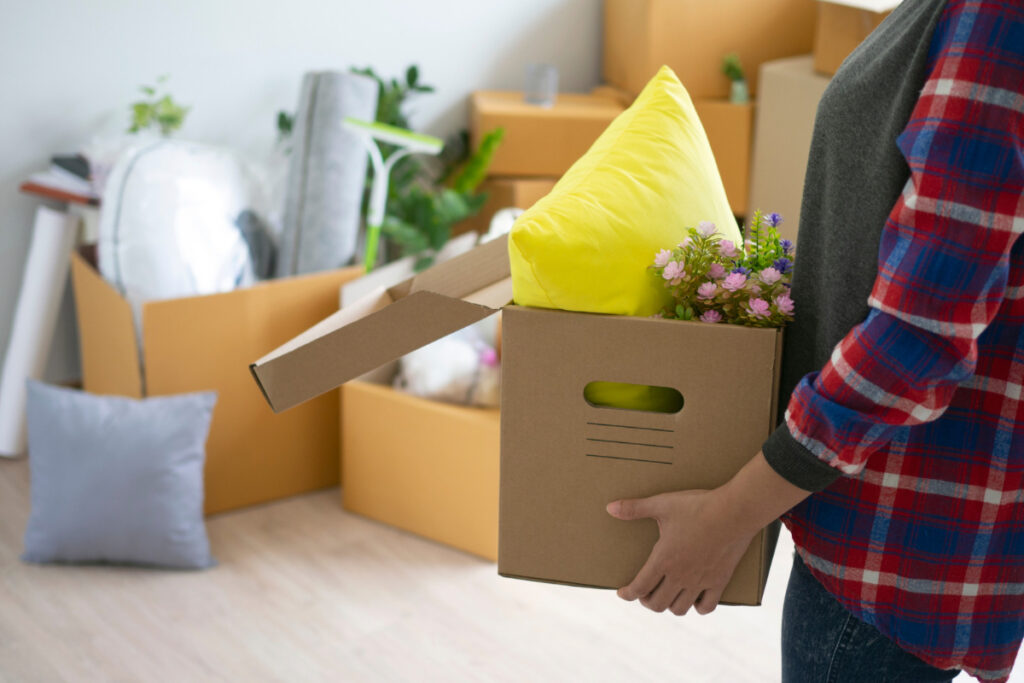 Selling home Berwyn Cicero homeowner packing personal belongings before listing.