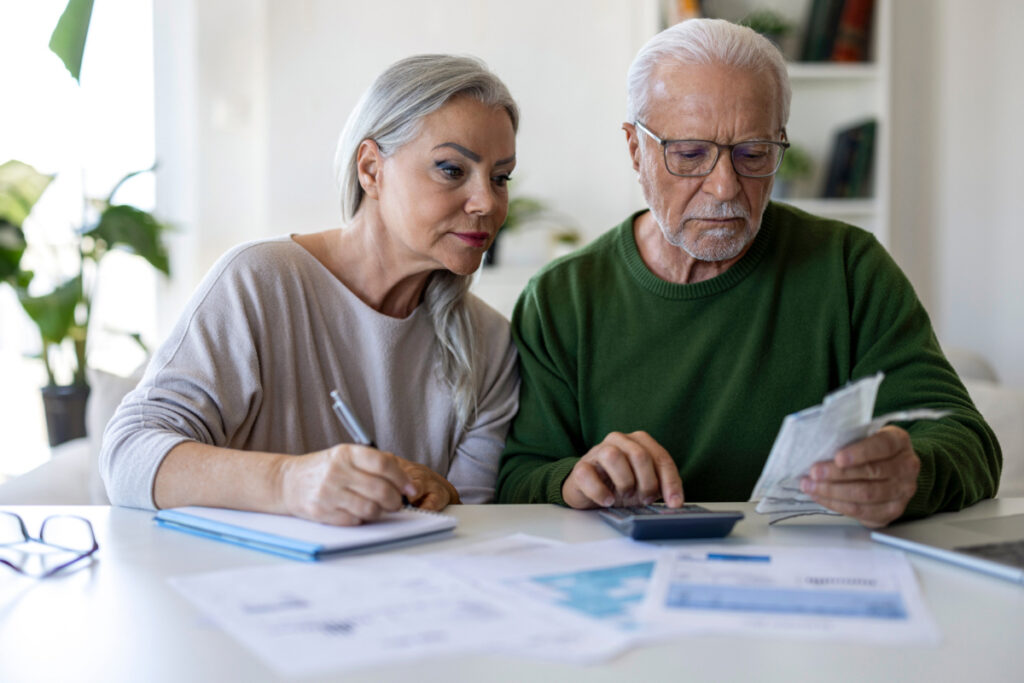 Homeowners reviewing retirement housing expenses and moving considerations.